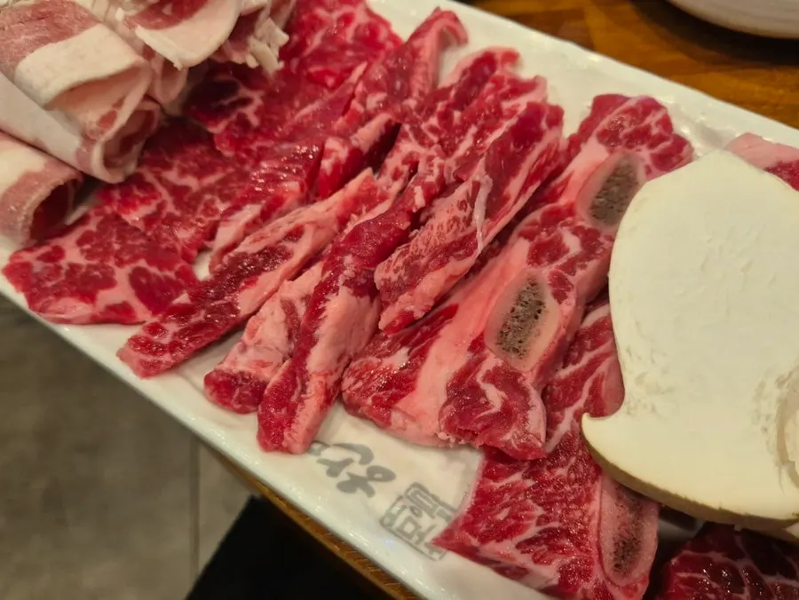 Bone-in galbi cooking on the grill