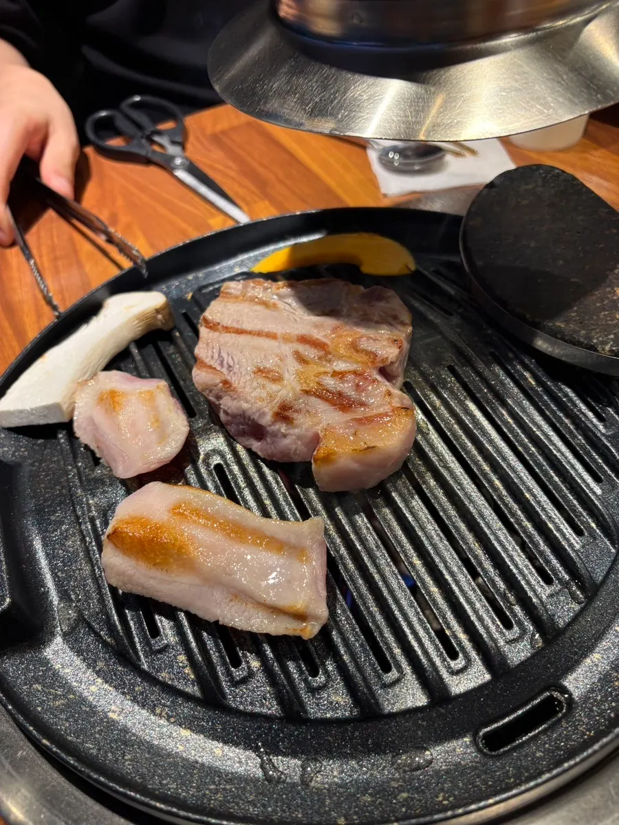 Raw cuts of pork belly, pork jowl, and other cuts