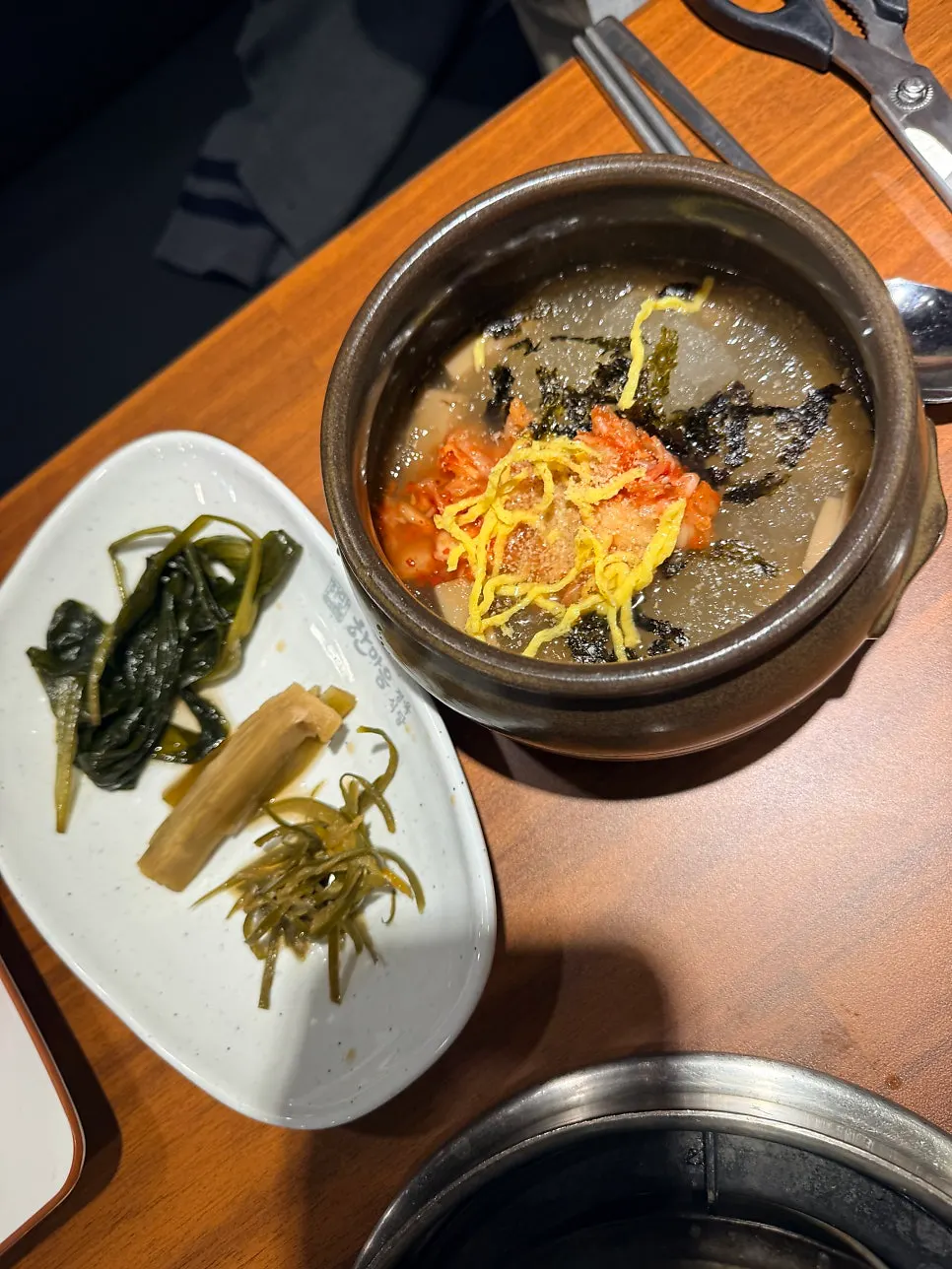 Generous side dishes including japchae and geotjeori
