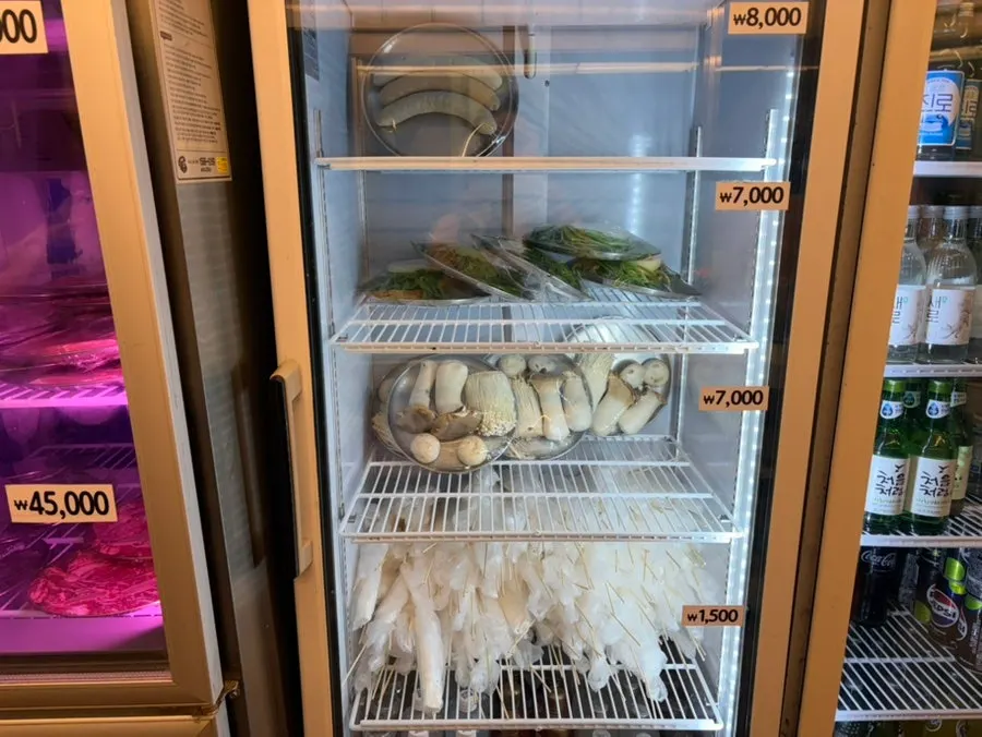 Menu board showing beef, pork, and tiger prawns