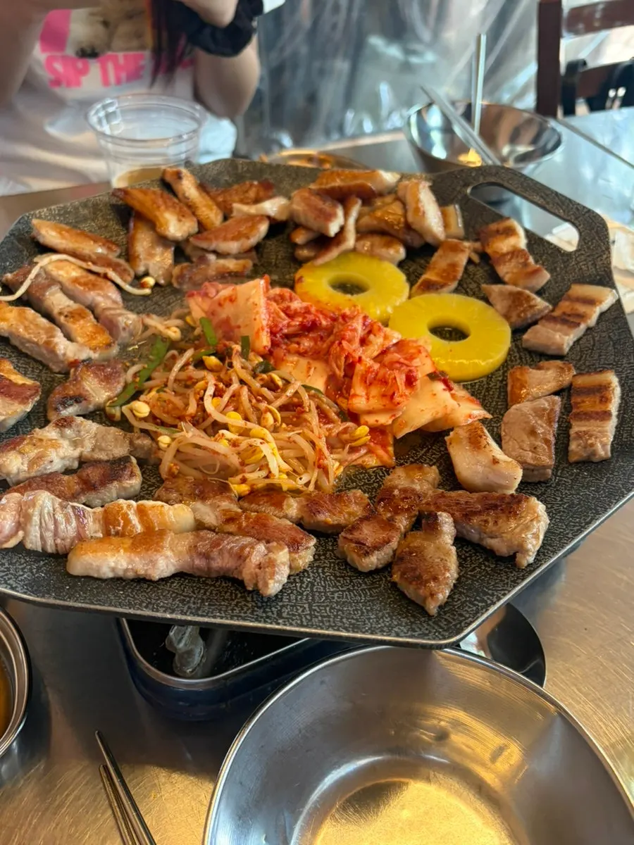Meat on the grill with a beer