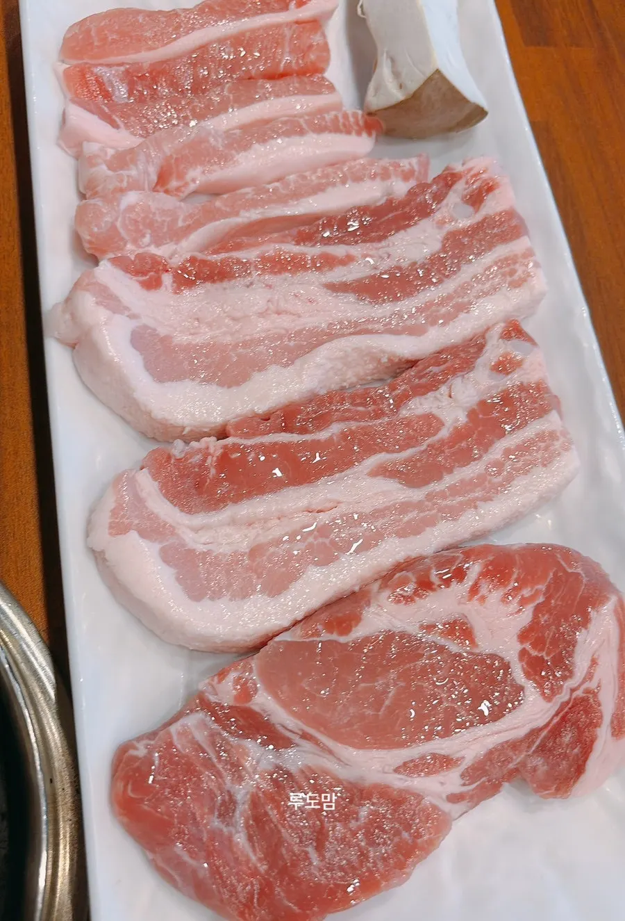 Half a pig's worth of pork grilling on the pan