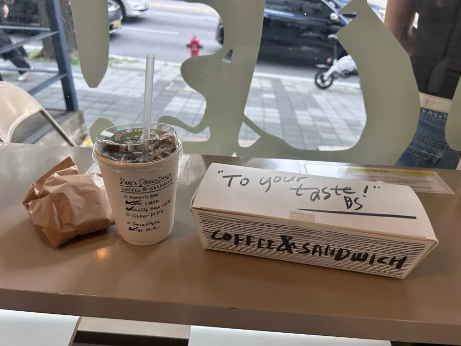Sandwich and coffee packed in a takeout bag