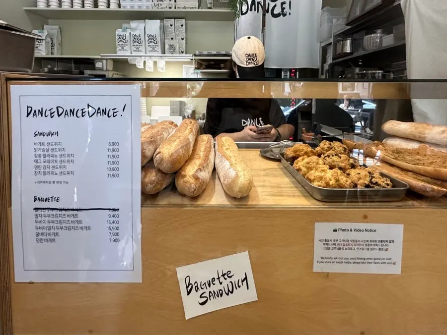 Menu board listing sandwiches and coffee