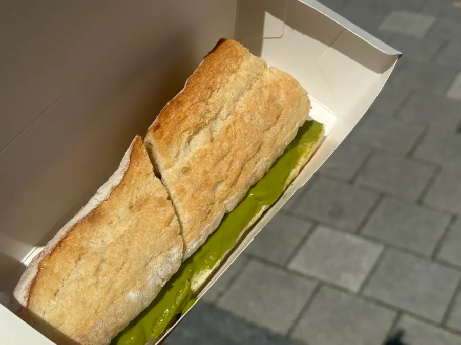 Cross-section of matcha tofu cream cheese baguette showing light cream amount