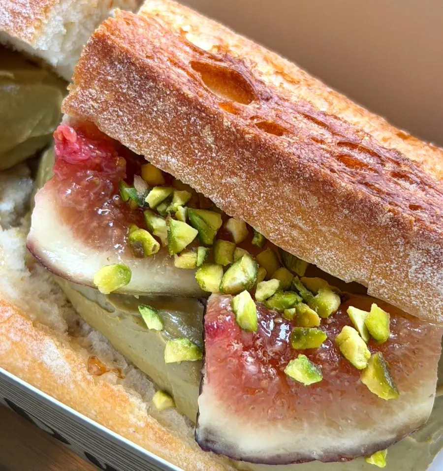 Baguette topped with fresh figs and crushed pistachio
