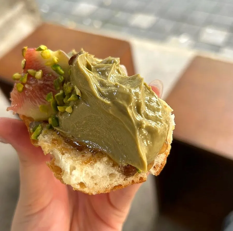 Cross-section of fig pistachio baguette with cream cheese