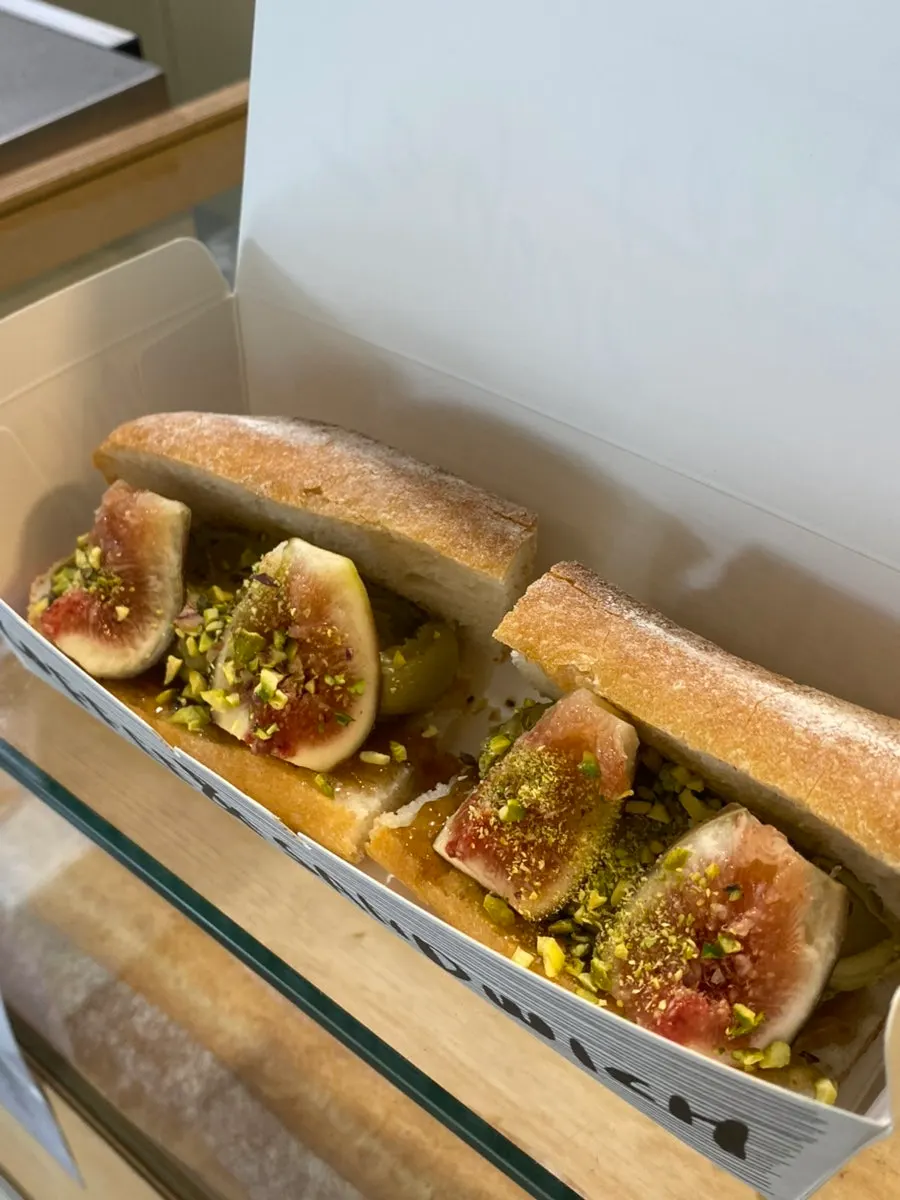 Cross-section of the baguette topped with figs and pistachio