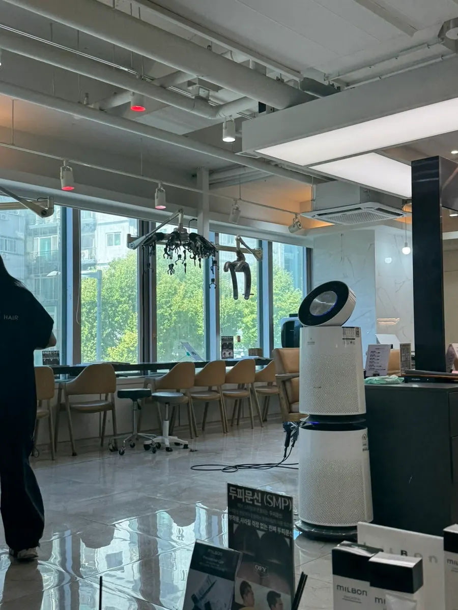 Salon interior with large windows and natural light