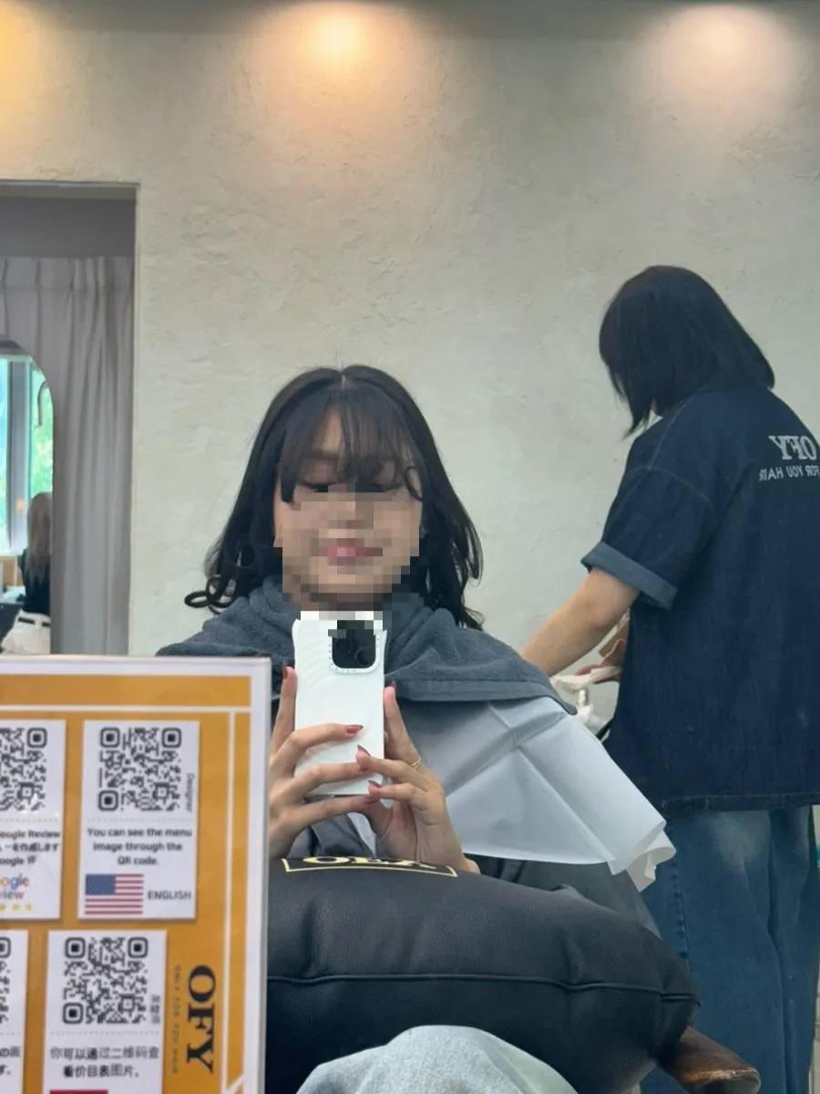 The perm process with hair wrapped in rollers