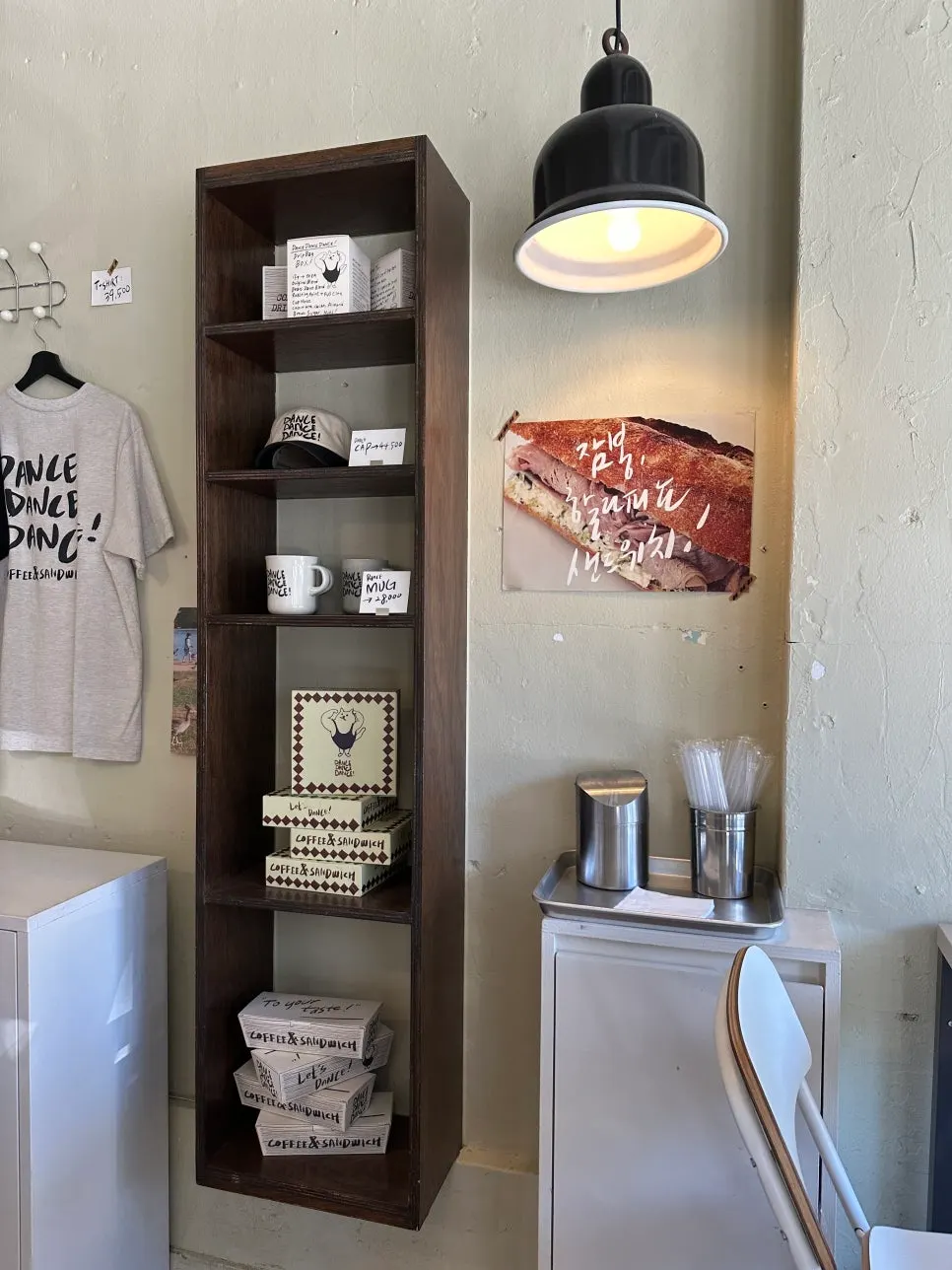 Interior of the store with clothes, hats, and cup merchandise on display