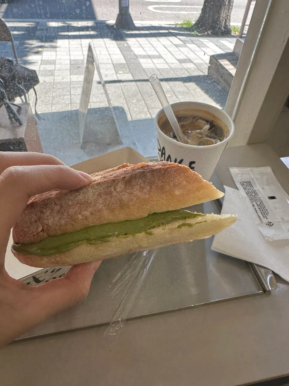 Matcha tofu cream cheese baguette with an iced americano