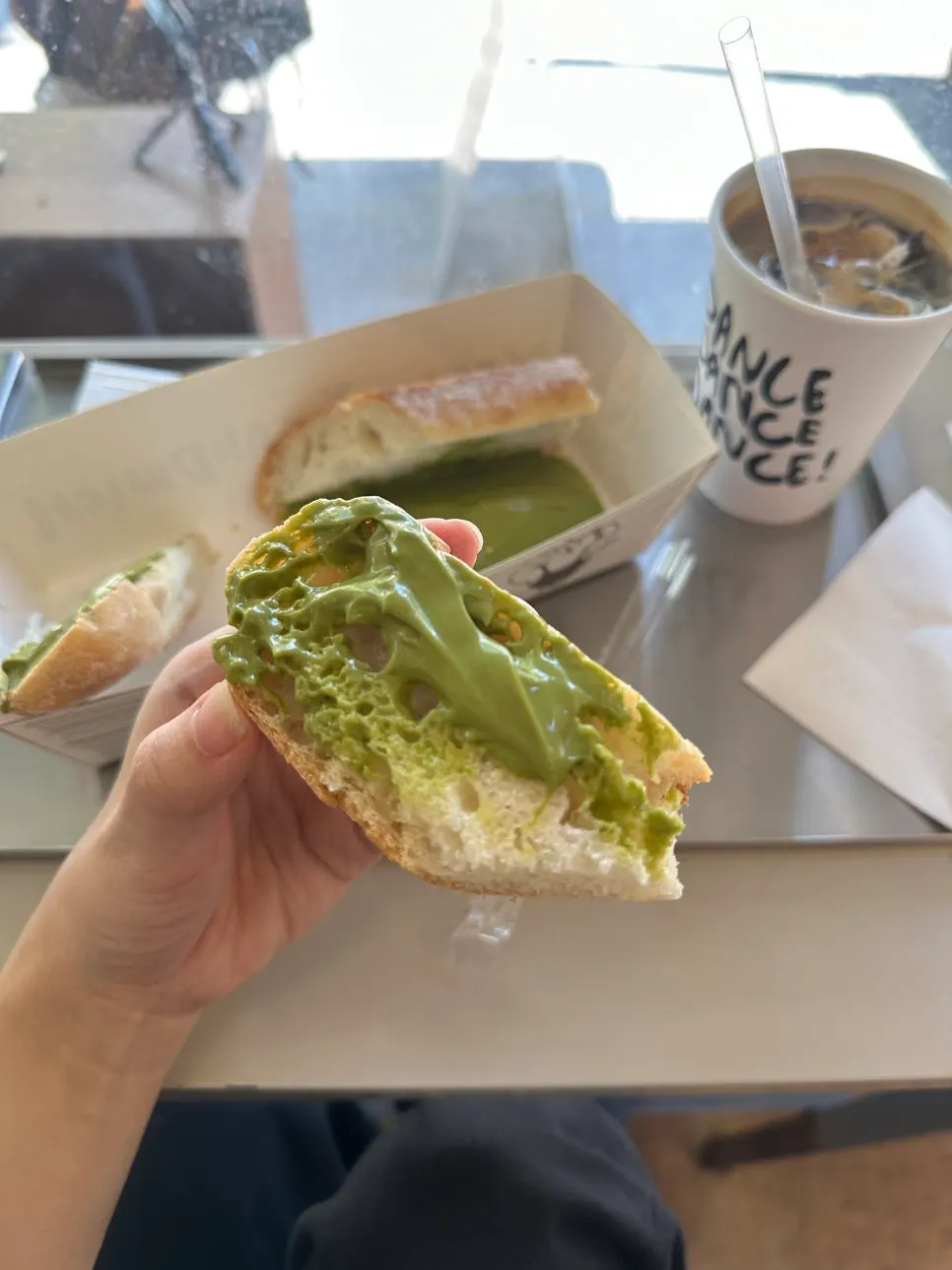 Cross-section of the matcha baguette packed with tofu cream cheese