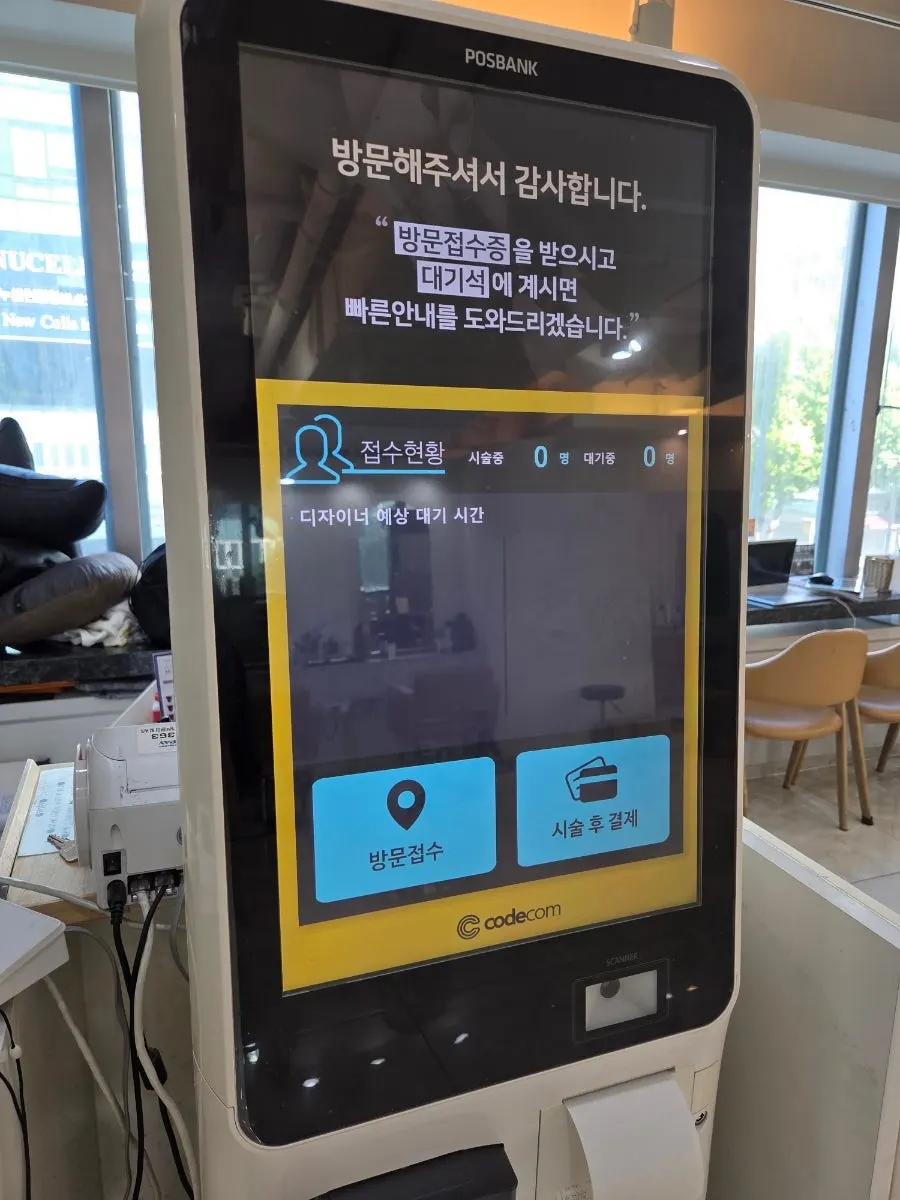 방문접수증을 작성하는 매장 안내 데스크