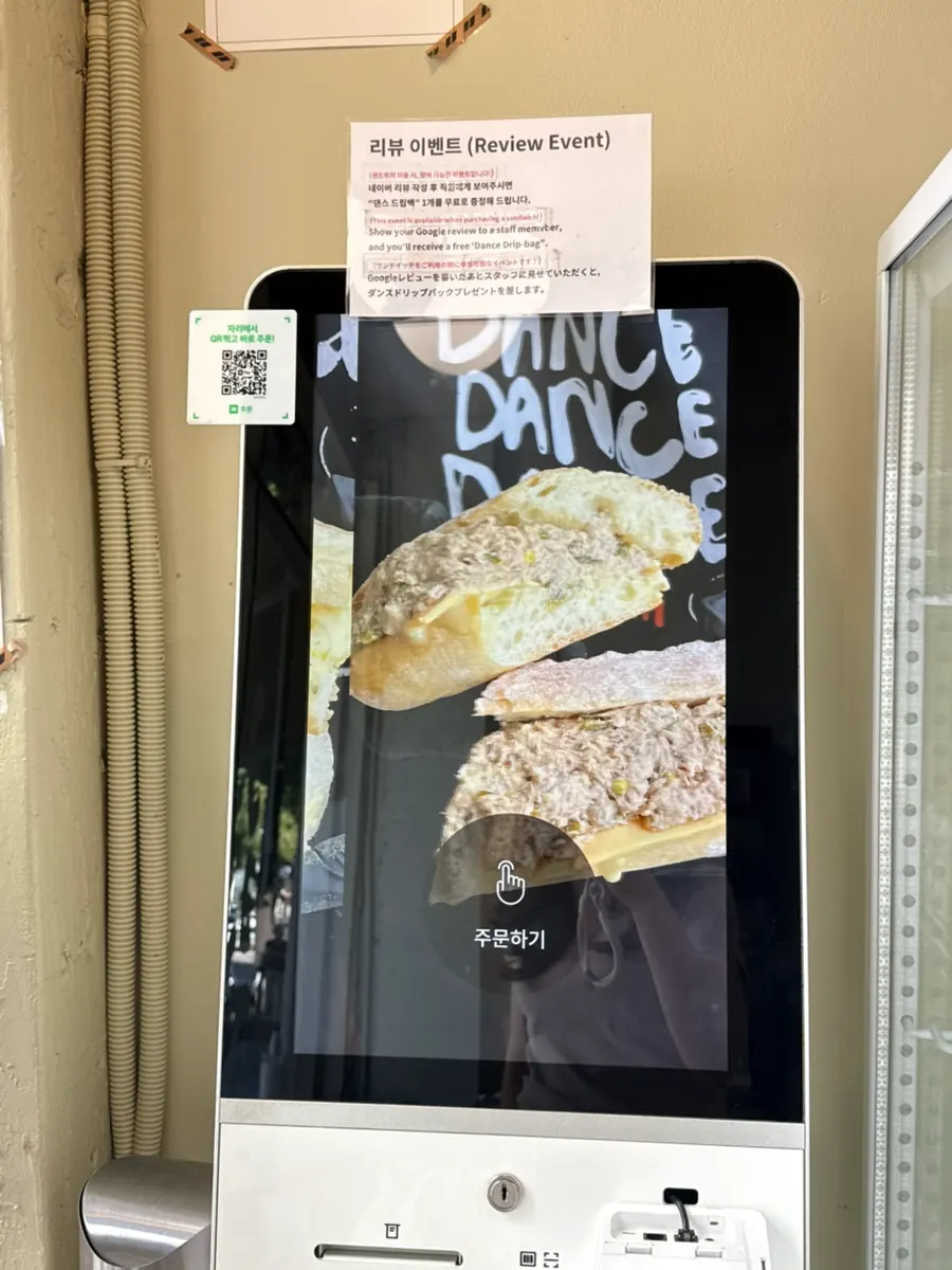 Packed takeout bag of Dance Dance Dance sandwiches