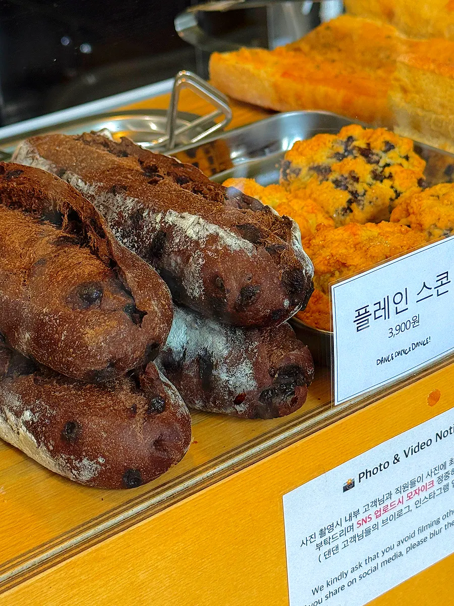 Scones and chocolate baguette displayed for sale