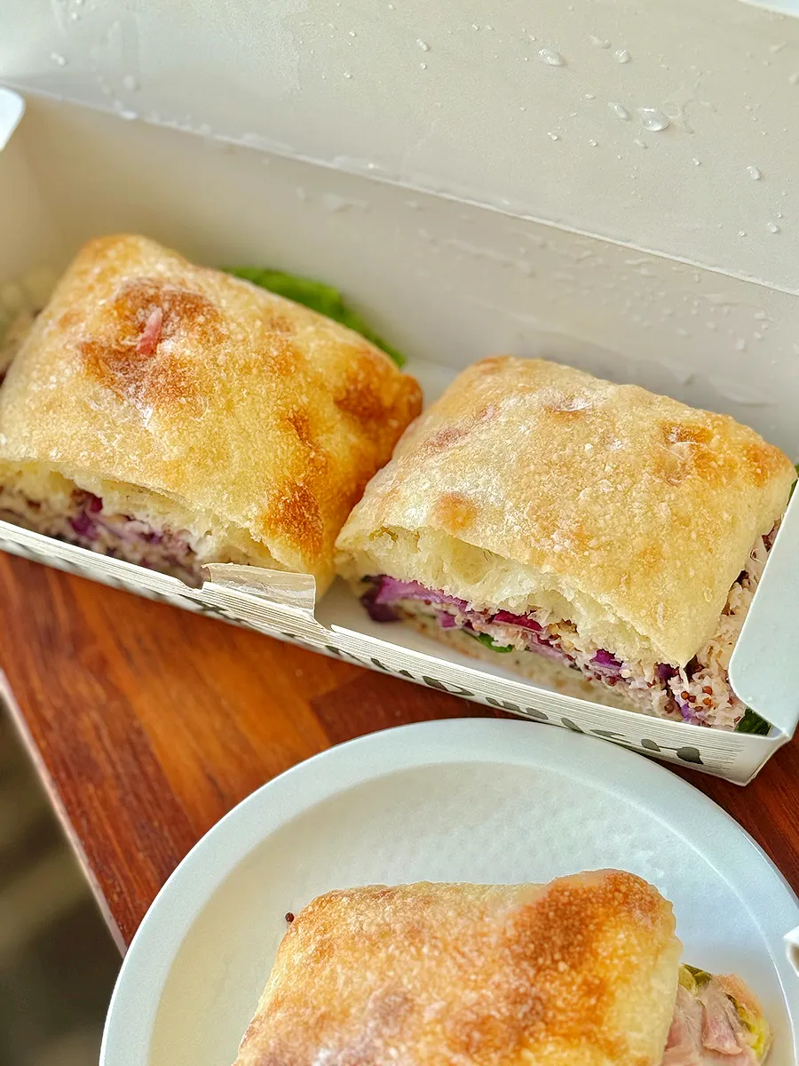 Two sandwiches packaged cut in half