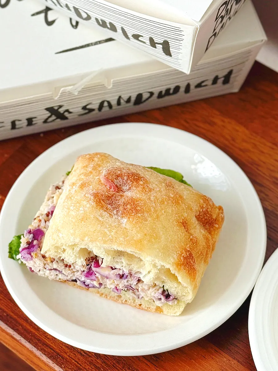 Cross-section of chicken breast sandwich on ciabatta
