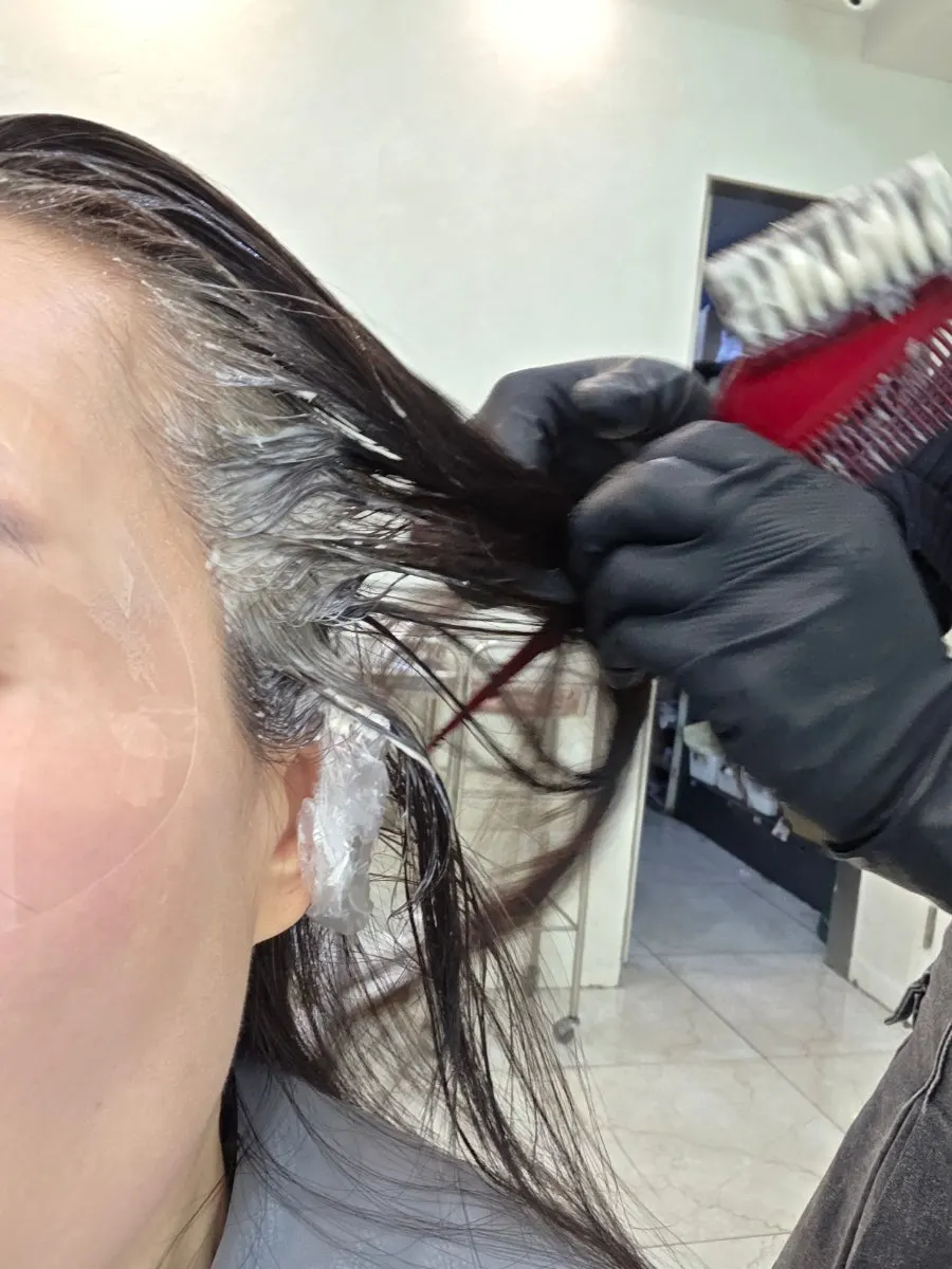 Preparing for dye with face cover and ear caps on