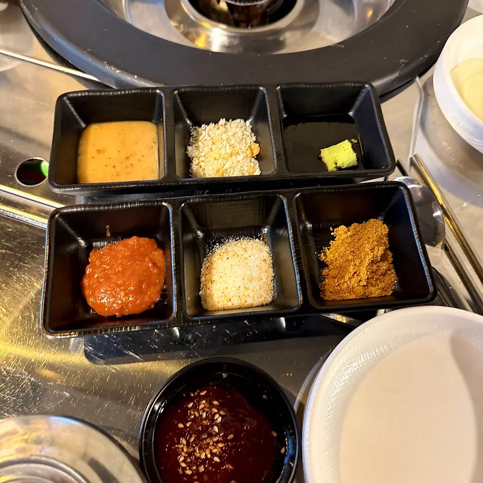 Plates of ssamjang and sesame sauce among others