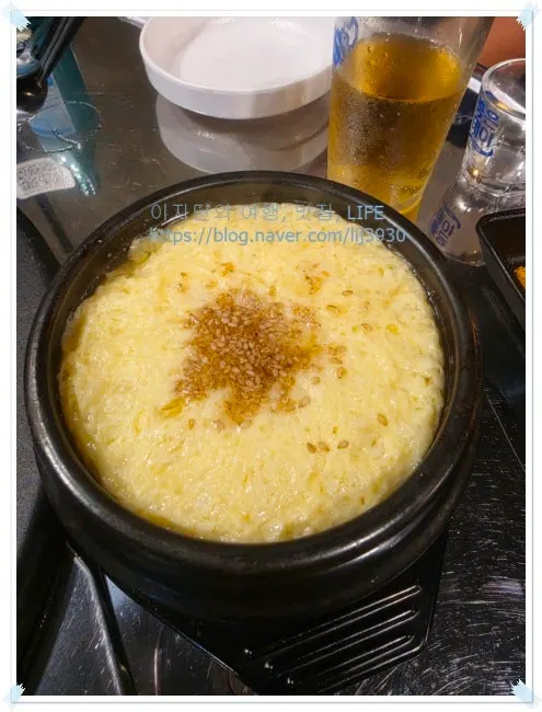 Complimentary steamed egg served in an earthenware bowl