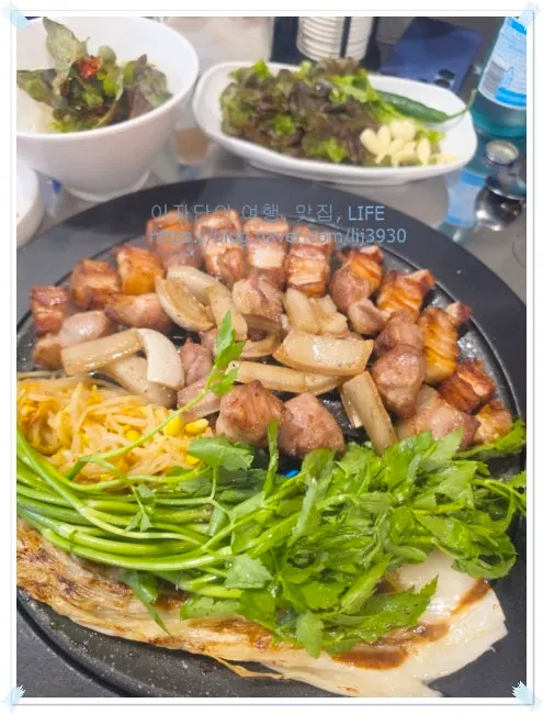 Fully-grilled pork belly, pork neck, pork skin and minari on an iron platter