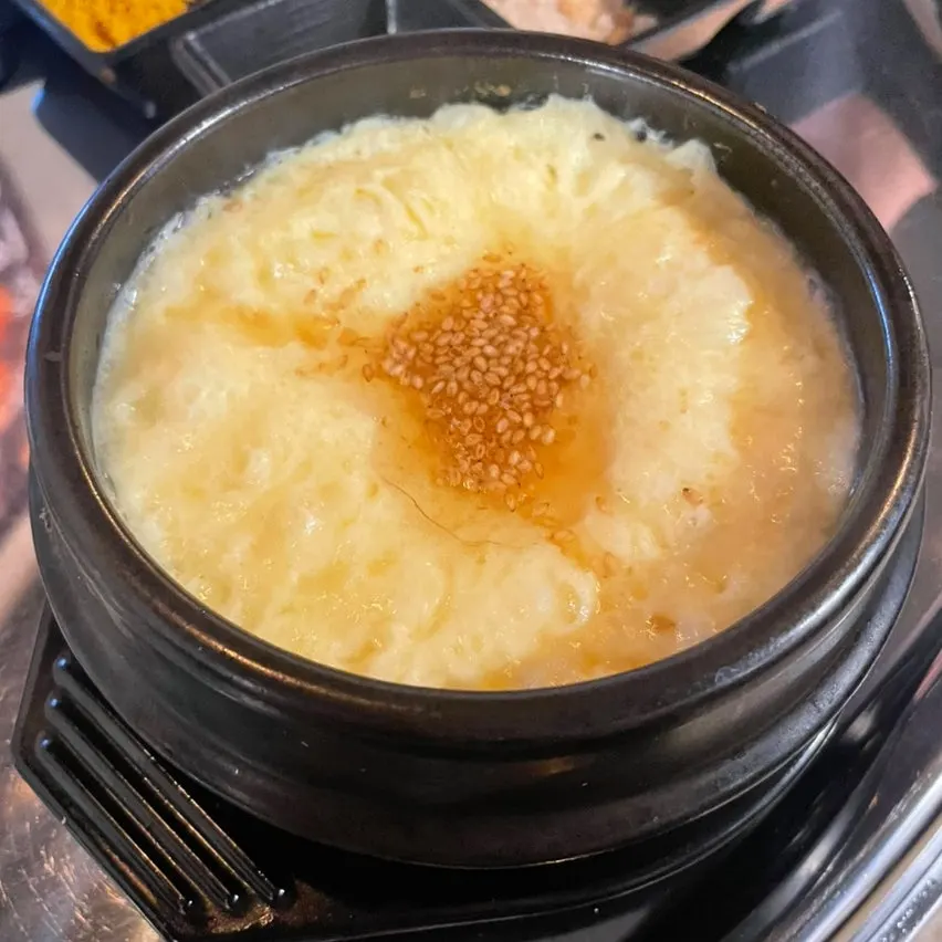 Complimentary steamed egg topped generously with sesame oil