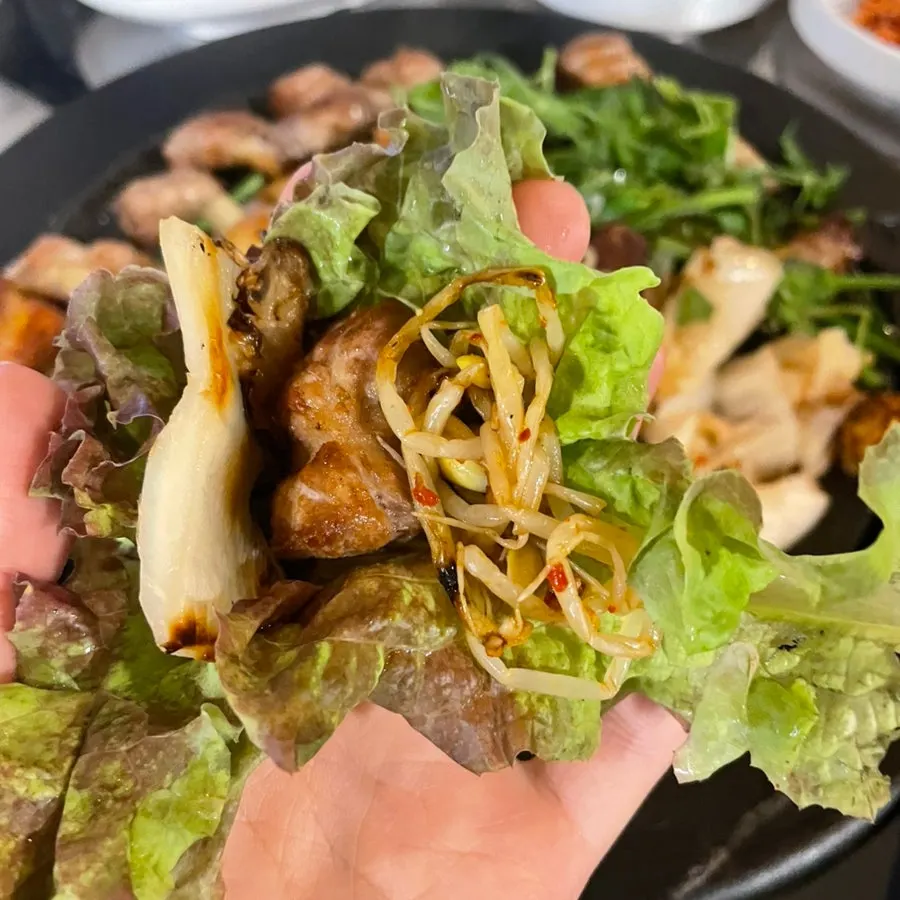 Minari pork belly wrapped in lettuce with side dishes
