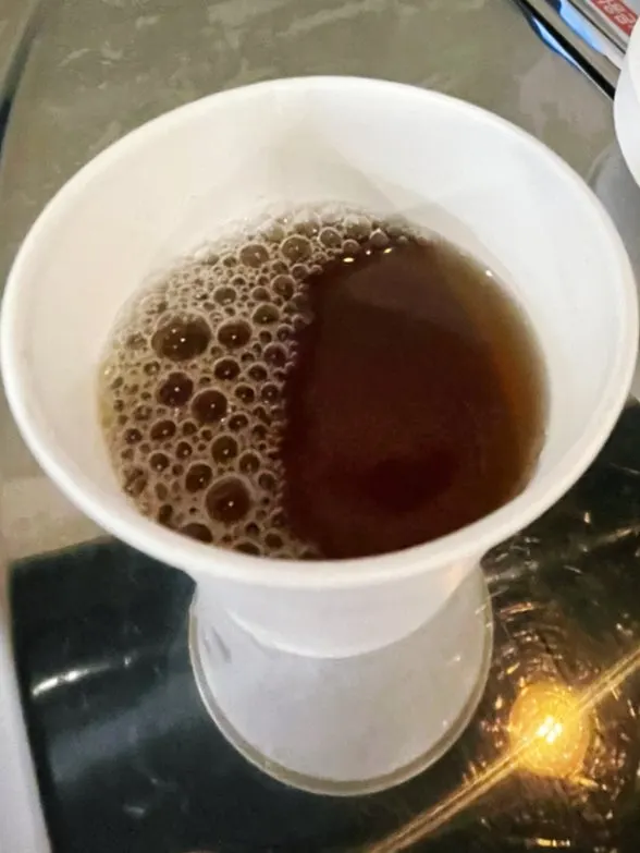 A glass of plum tea enjoyed as a palate cleanser