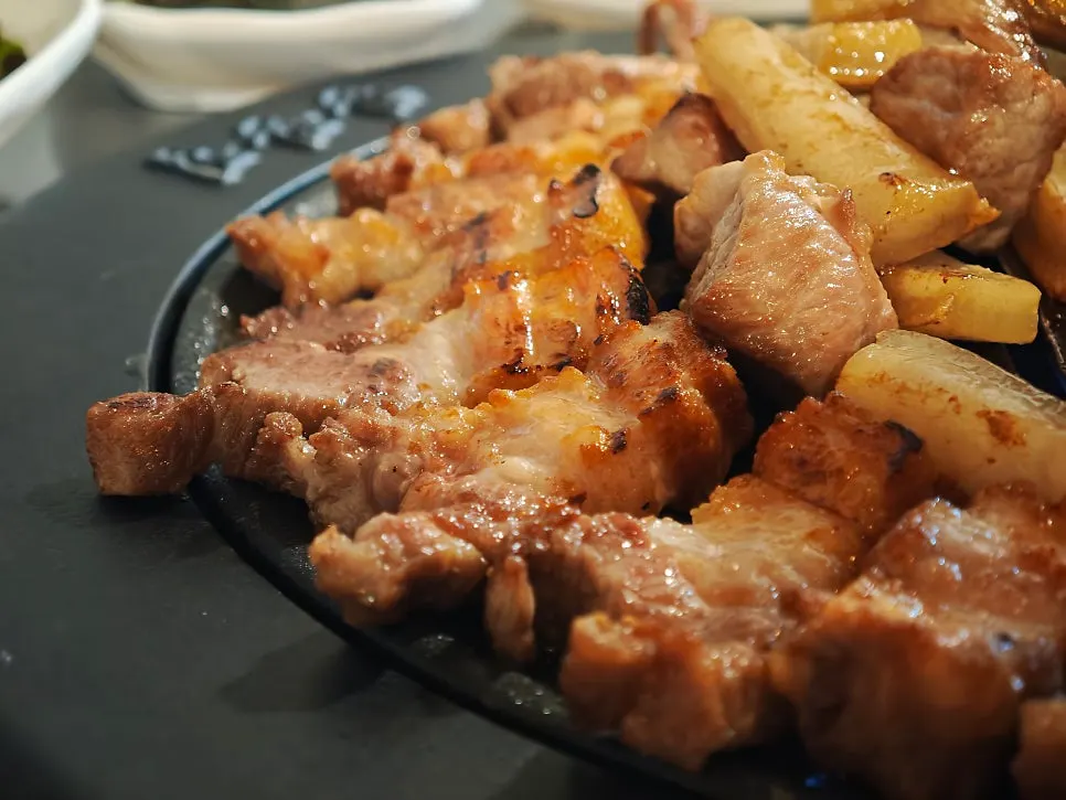 Meat wrapped with minari, white kimchi, and bean sprouts