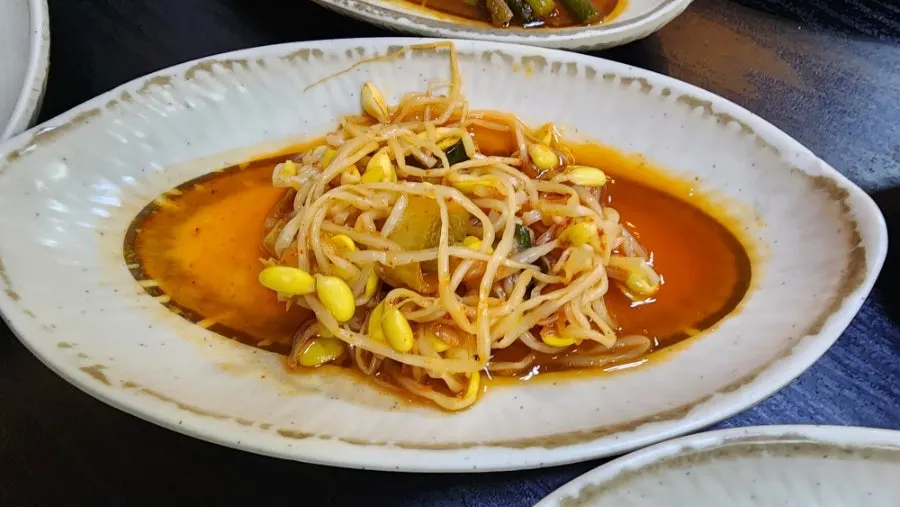 Glistening plate of boiled pork bossam