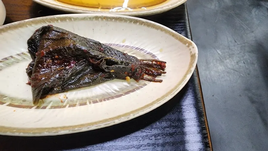 Plates of salted shrimp, ssamjang, and garlic condiments