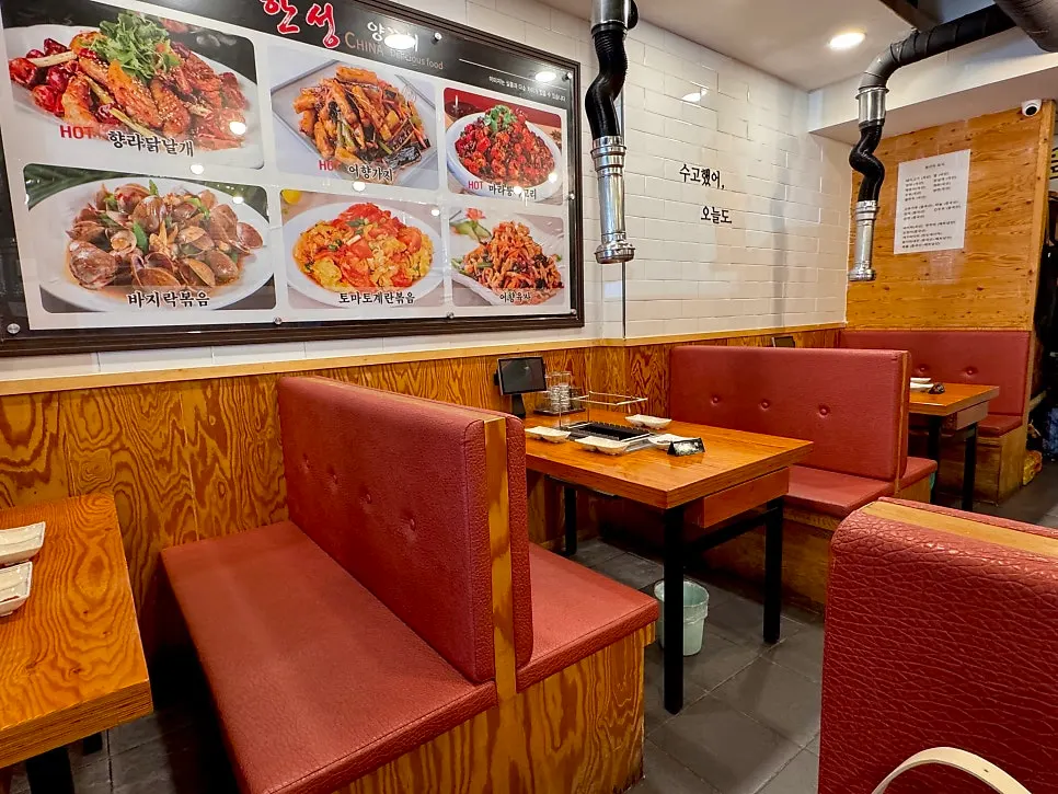 Table seating with a grill and hood installed at each table