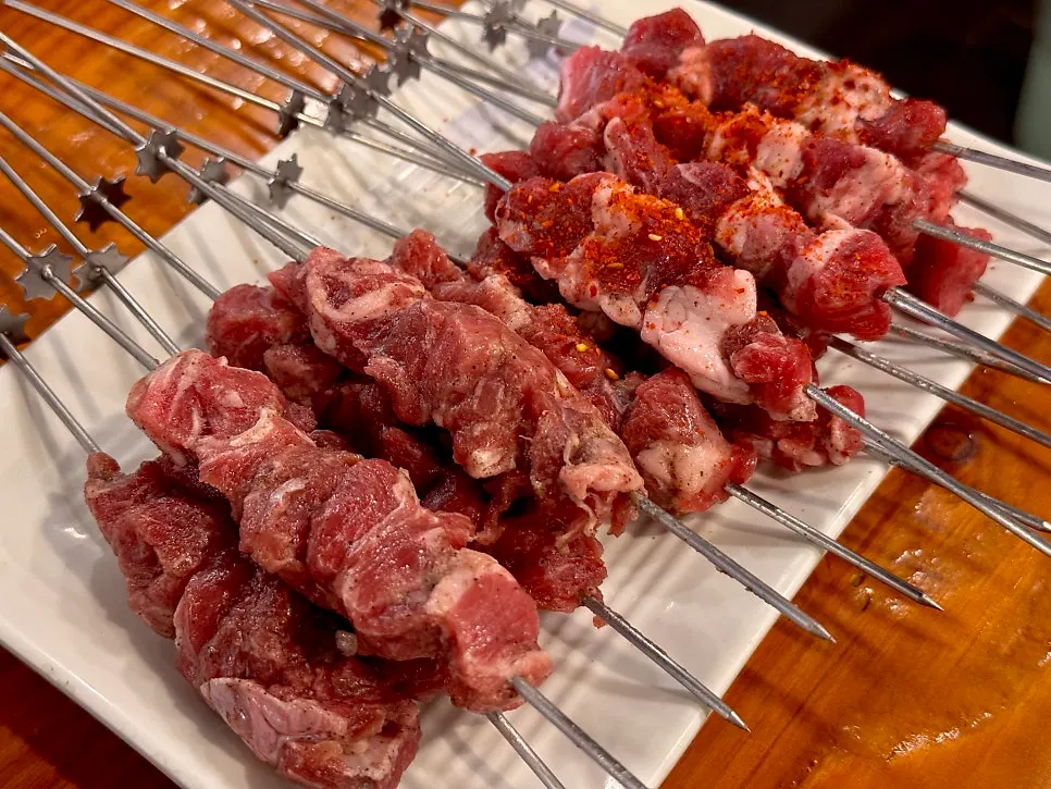 A plate piled high with lamb loin skewers