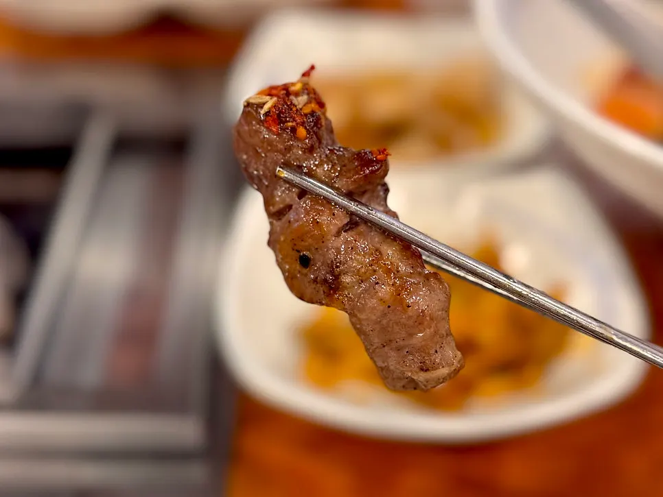 A lamb loin skewer dipped in cumin salt