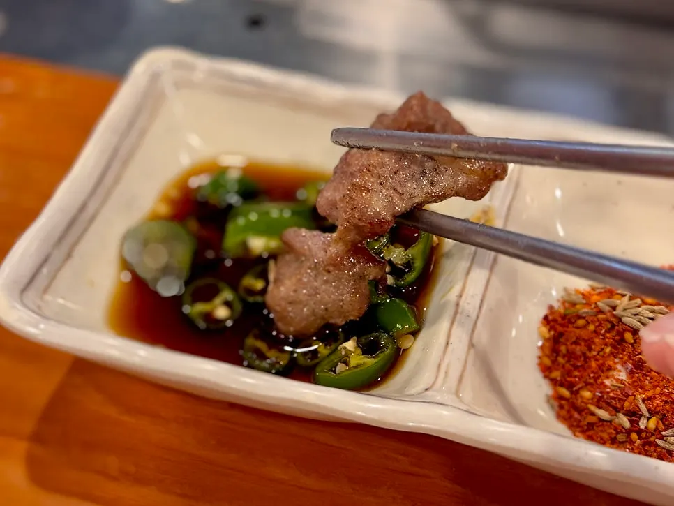 Soy sauce with cheongyang chili next to lamb skewers