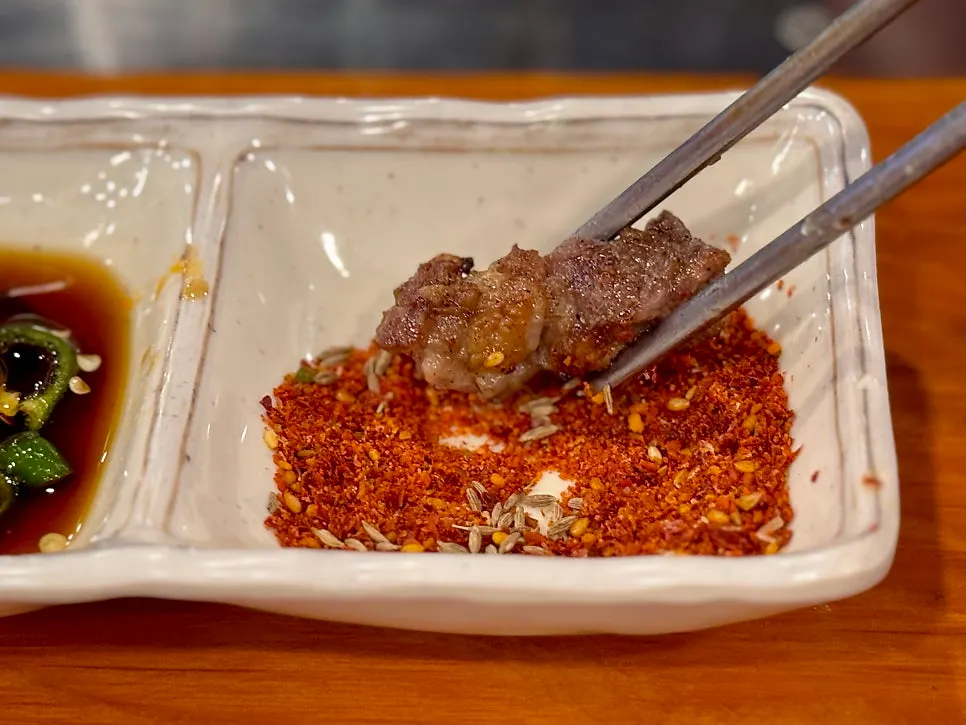 A lamb rib skewer heavily coated in cumin salt