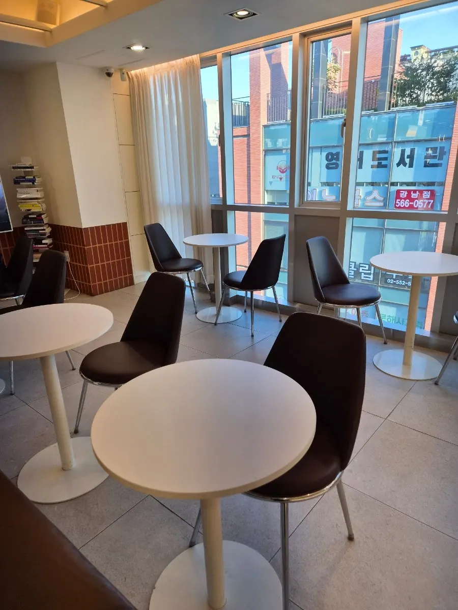 Waiting area with a window-side table and chairs