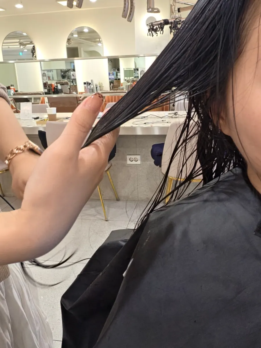 Parting hair section by section to apply product carefully