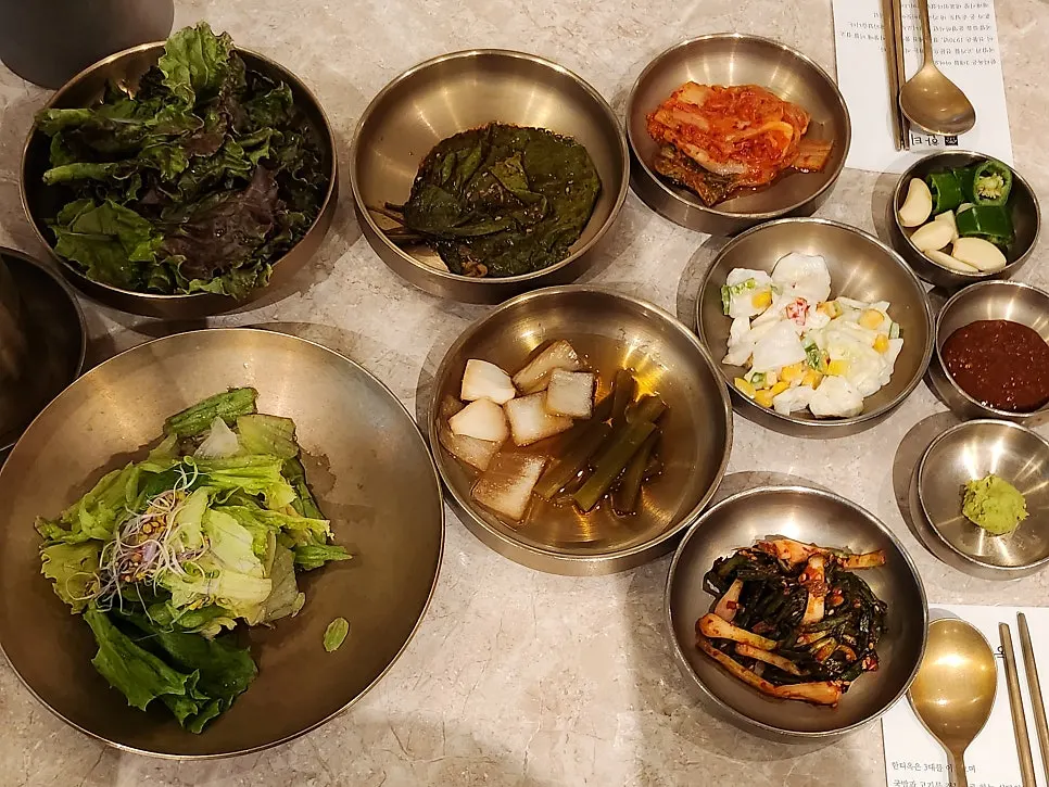 Basic side dishes including scallion kimchi and pickled perilla leaves