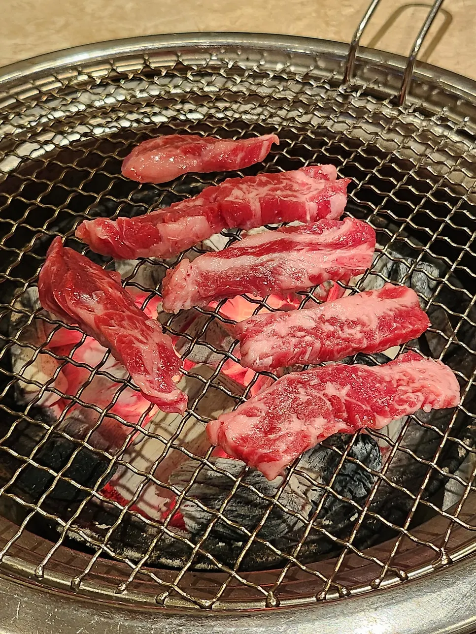 Rib meat and mushrooms sizzling on the grill