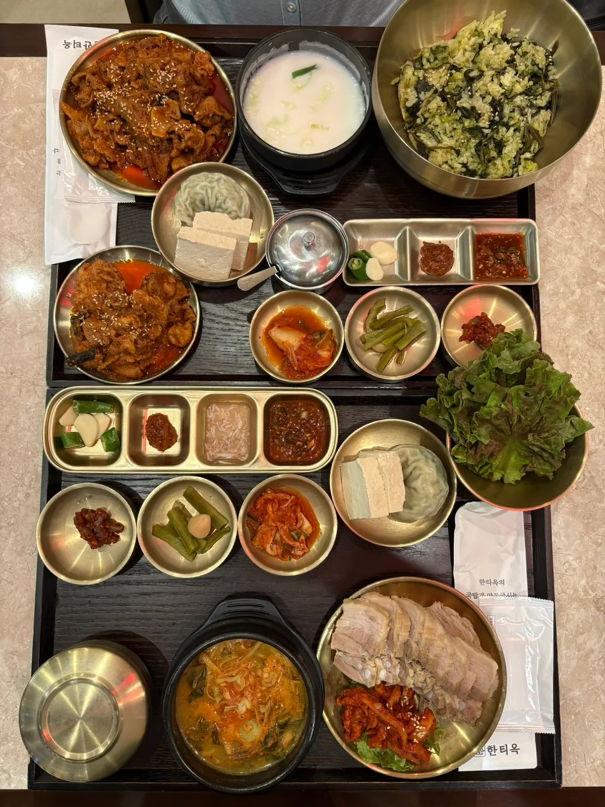 Table filled with the bossam set and gondre bibimbap set
