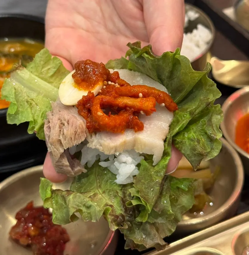 Bossam and radish kimchi wrapped in lettuce