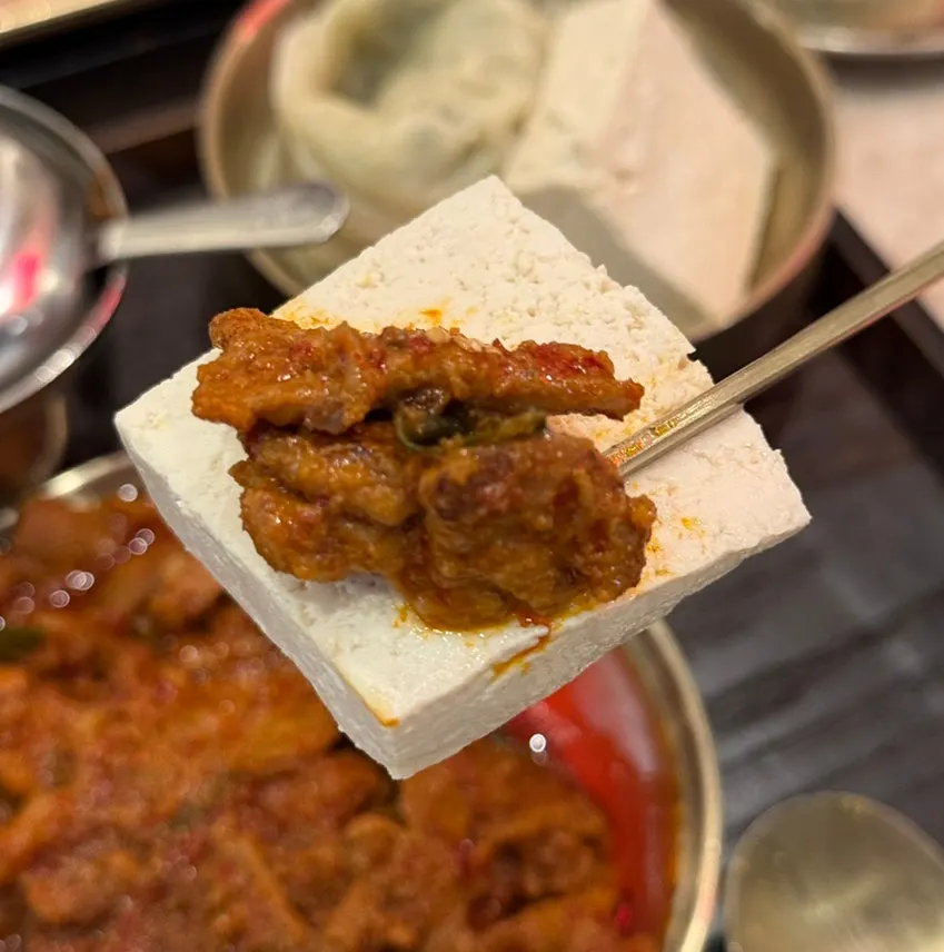 Plate of stir-fried pork served with tofu
