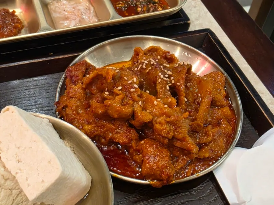 Wang mandu, tofu, and jeyuk bokkeum side dishes
