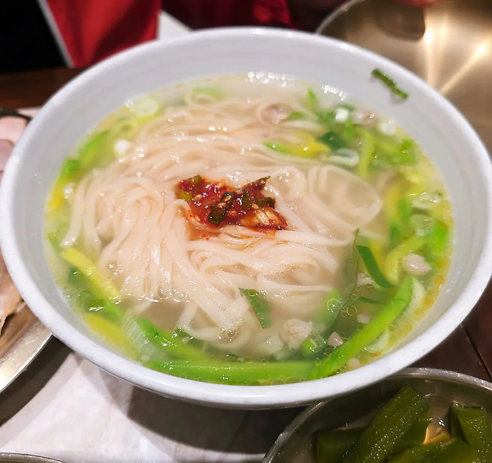Noodles being lifted from the andong guksu bowl