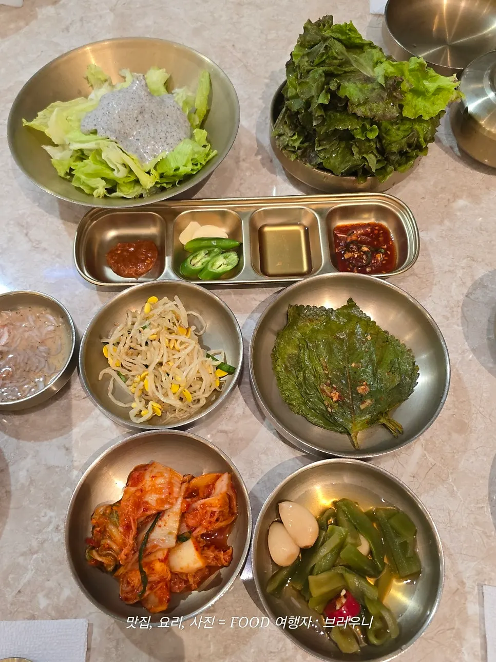A wrap of bossam topped with radish kimchi