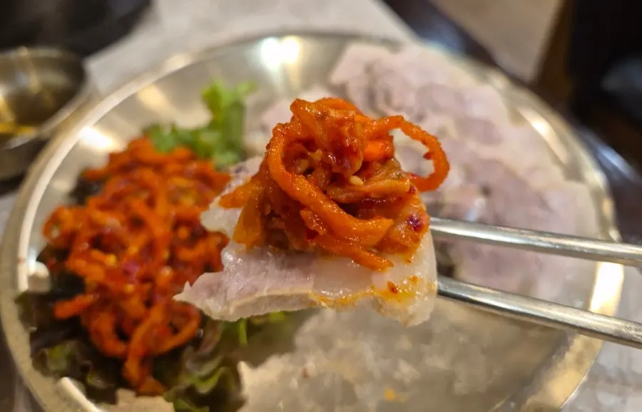 Crunchy radish salad served alongside the boiled pork