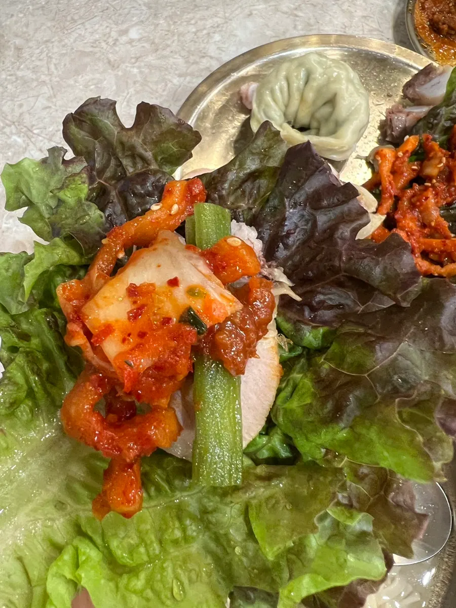 Bossam wrapped with pickle and pickled radish