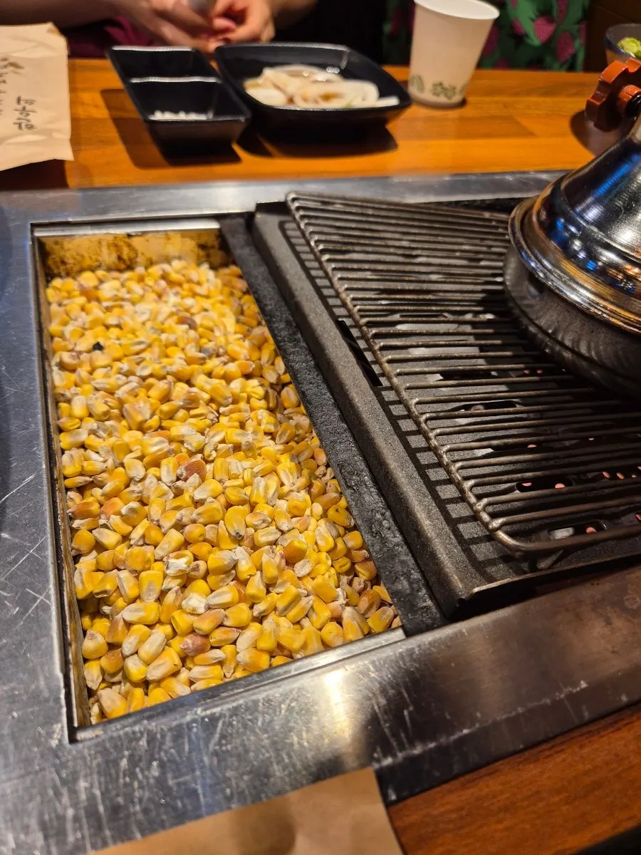 Corn kernels used as fuel placed beside the grill